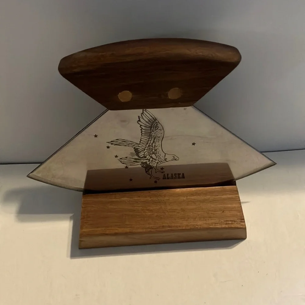 Alaskan Ulu knife with a walnut wood handle and‎ a stand.